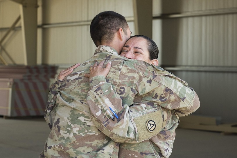 two military personnel hugging