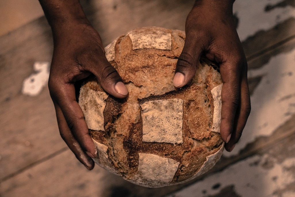 photo of hands holding bread