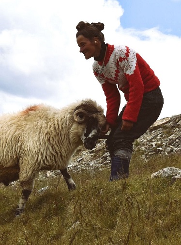 photo of a sheperdess with a sheep