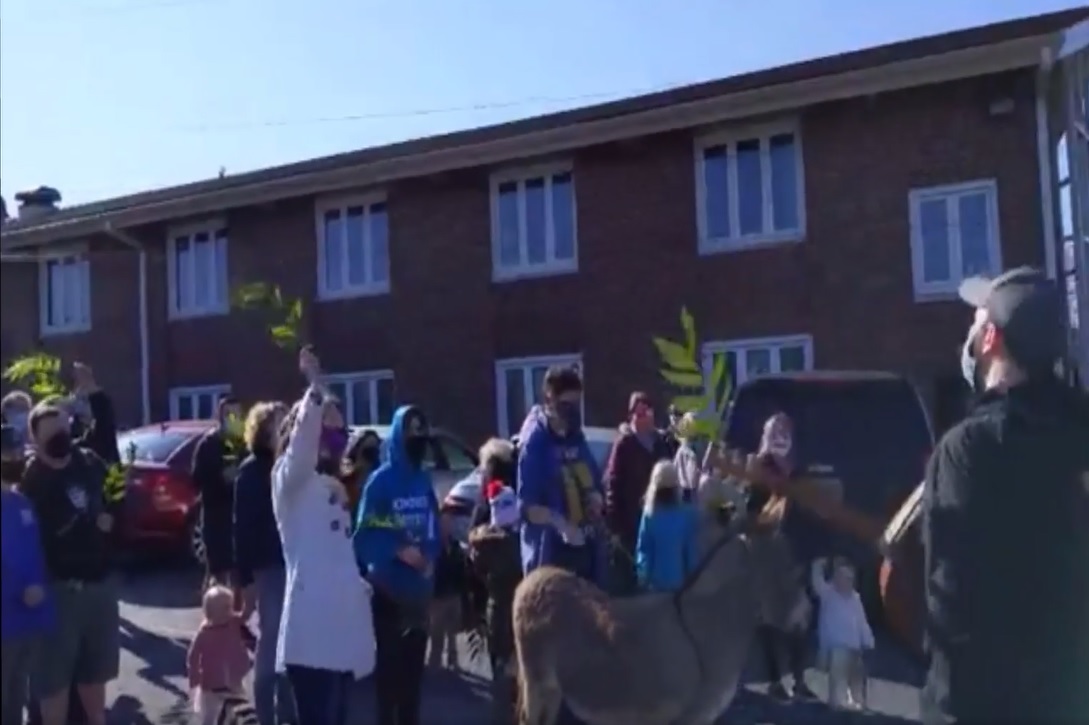 photo of parishioners with donkey outside of the church