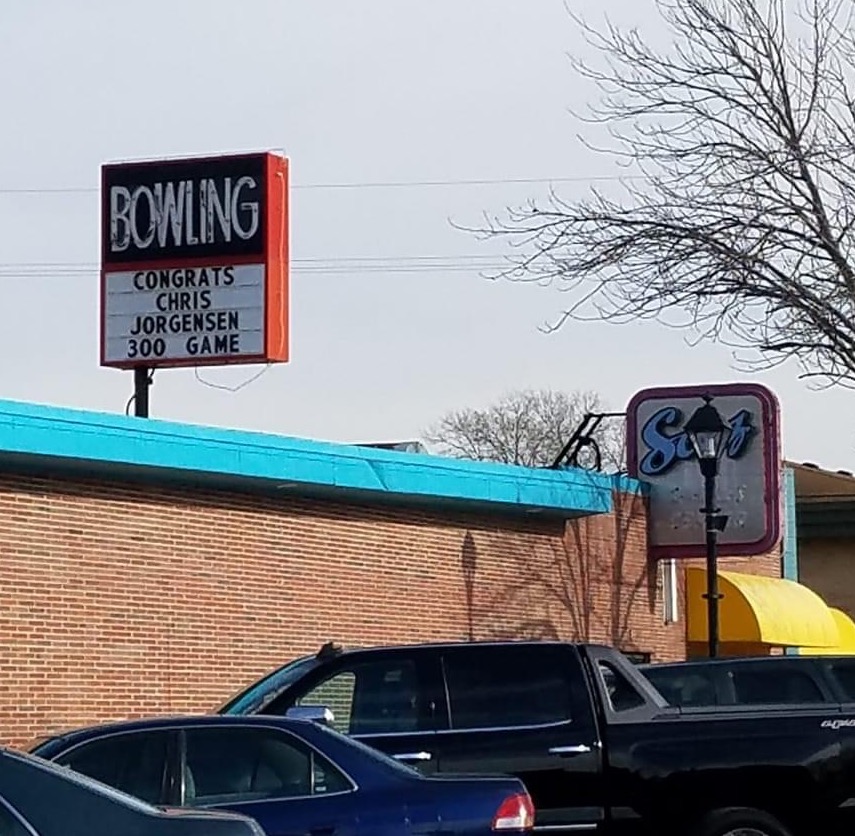 photo of a bowling alley sign showing chris jorgensen got a 300 score