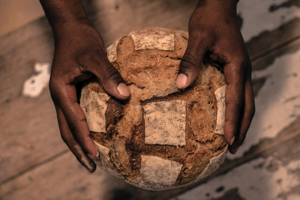 photo of bread with hands